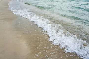 Sea wave on the clean sandy shore of the Black Sea