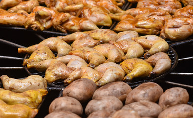 Poultry and potatoes on grill
