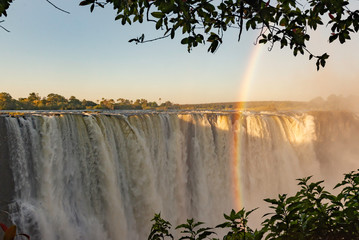 picture of the Victoria Falls and a rainbow while teh sun goes down, beautiful sunset