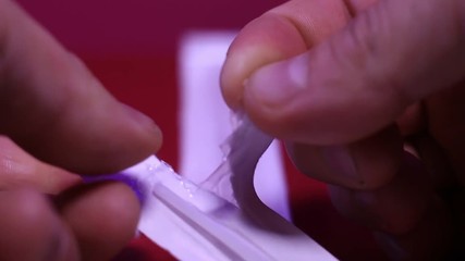 Close-up of removing one cheek swab from its wrapper. - Powered by Adobe