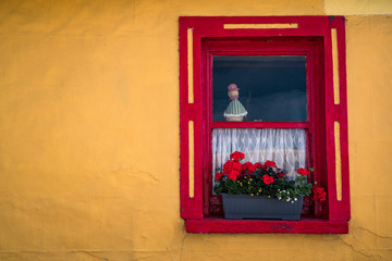Colorful window flower box on vintage Irish cottage