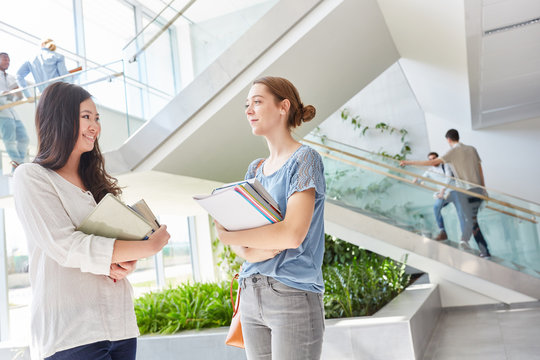 Two women as students with books