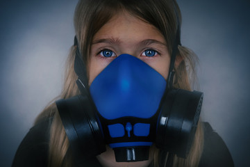 Fototapeta na wymiar Young girl wearing gasmask, respirator portrait. Effects of worldwide air pollution, industrial influence on environment. Protection from dangerous air particles, gas, smog, transmitted diseases