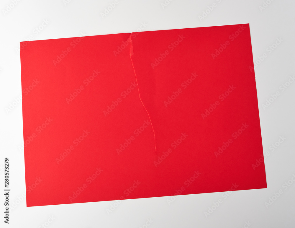 Poster torn in half empty red sheet of paper on white background