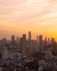Panorama of cityscape with sunset over the building and blue sky at bangkok ,Thailand. View Vertical of the tall building in capital with twilight .Shot using Panorama technique.