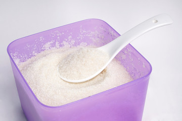 white sugar with spoon white background
