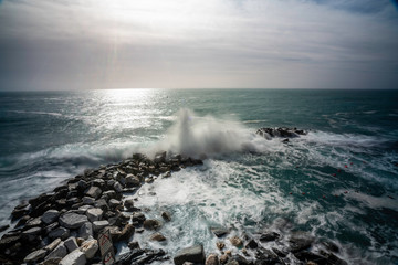 Wave hitting a waterblock in Italy - Riomaggiore