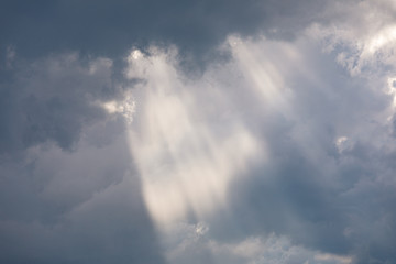 Naklejka na ściany i meble Vivid sunbeam light ray from clouds