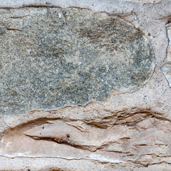 Typical wall of ancient Italian house made of hand-carved stones and bricks