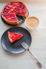 Sweet dessert with strawberries, cheesecake cake with slices of berries in jelly on top.