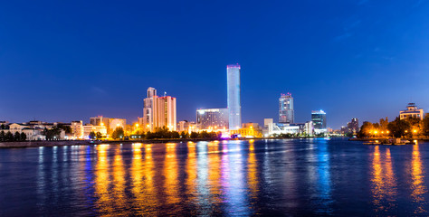Fototapeta na wymiar Night view of the skyscrapers of the city of Yekaterinburg. Russia. Reflection in the river