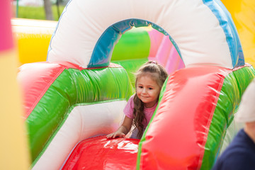 A cheerful child plays in an inflatable castle