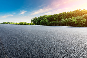 Asphalt highway and green forest with beautiful cloud landscape at sunset