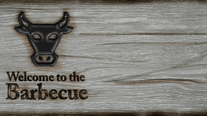 Welcome to barbecue - old wooden plate with metal font and bull's head