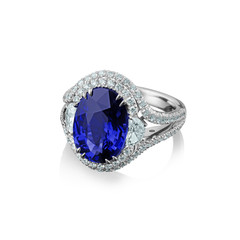 Isolated white gold ring with diamonds and huge blue sapphire