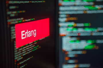 Programming language, Erlang inscription on the background of computer code.