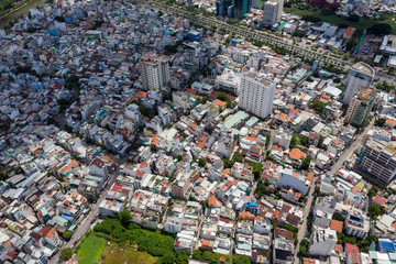 Top View of Building in a City - Aerial view Skyscrapers flying by drone of Ho Chi Mi City with development buildings, transportation, energy power 
