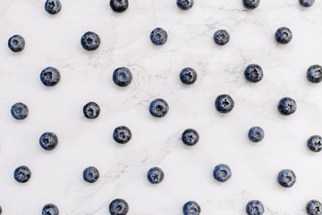 Flatlay pattern with fresh ripe blueberries isolated on white background. Top view minimal concept.