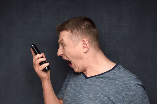 Portrait of furious man arguing with somebody via phone