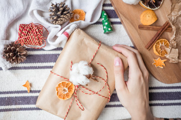 Woman's hands holding a Christmas/new year present