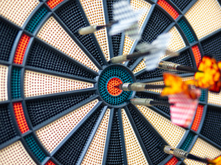 Picture of Darts arrow hitting in the target center of dartboard. concept business goal to marketing success. Business target or goal success and winner concept. success and risk management.