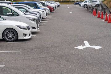 row of cars parked in outdoor parking