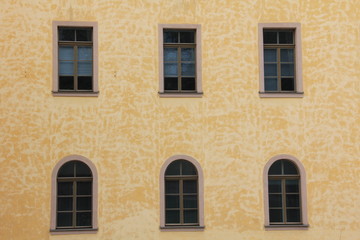 Fototapeta na wymiar Windows on old stone wall