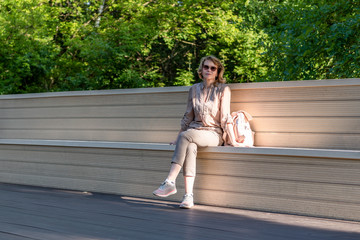 A woman is resting on a park bench.