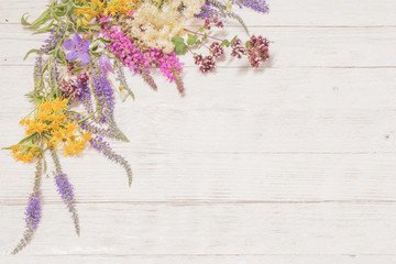 wildflowers on white wooden background
