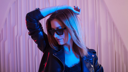 Beautiful girl dancing in retro wave on the neon light