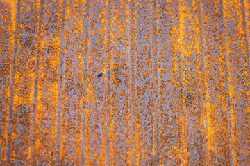 Old rusty surface with orange rust and leading lines. Texture, backdrop and pattern concept.