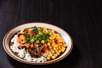 Rice with chickpea and vegetables on wooden table