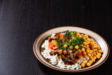 Rice with chickpea and vegetables on wooden table