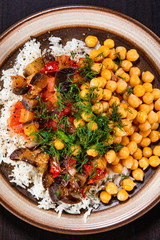 Rice with chickpea and vegetables on wooden table