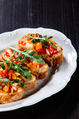 Bruschettas on plate on wooden background
