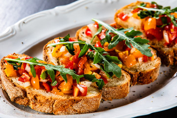 Bruschettas on plate on wooden background