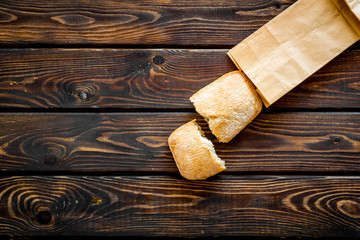 Bakery with fresh french baguette loaf on wooden background top view mockup