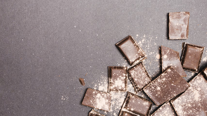 Top view chocolate tablets covered in cocoa powder