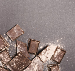 Top view dark chocolate covered in cocoa powder
