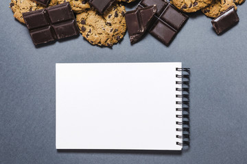 Top view chocolate frame with notebook