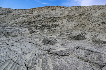 Desert sand dune like moon surface. Abstract fantastic view of the surface with sand and stones. Beautiful surreal landscape of dry dead ground.