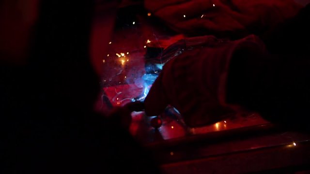 A slow mo close up shot of apprentice learning the ropes on a construction site, futuristic industrial practice sparks flying around quick fix on this job career