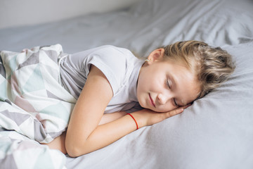 Obraz na płótnie Canvas Cute girl sleeping in bed. Scandinavian style