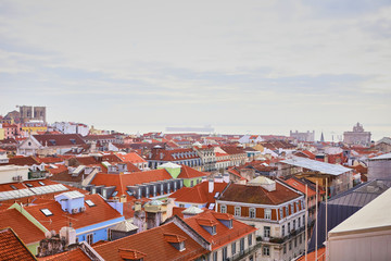 Fototapeta na wymiar Lisbon Portugal - Beautiful panoramic view of the red roofs of houses in antique historical district Alfama and bridge from Sao Jorge Castle
