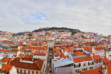 Fototapeta na wymiar Lisbon Portugal - Beautiful panoramic view of the red roofs of houses in antique historical district Alfama and the Tagus River and bridge from Sao Jorge Castle