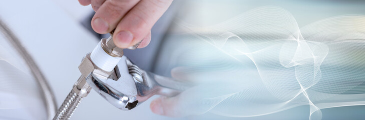 Plumber screwing plumbing fittings; panoramic banner