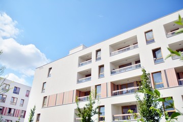 modern apartment building with blue sky and clouds