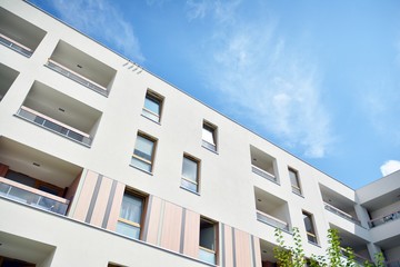 modern apartment building with blue sky and clouds