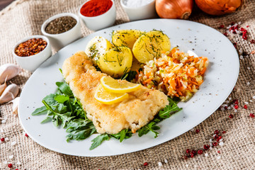 Fish dish - fried fish fillet boiled potatoes and vegetables
