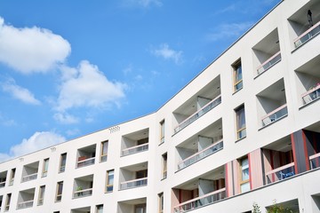 modern apartment building with blue sky and clouds
